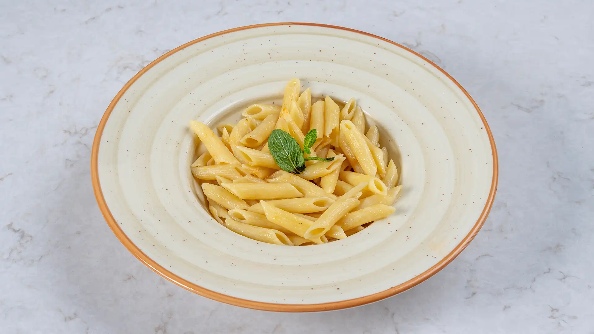 Close-up of halal multicultural pasta served at The Cozy Revolution in Richmond, Texas, highlighting rich sauce and fresh ingredients in a cozy dining atmosphere.