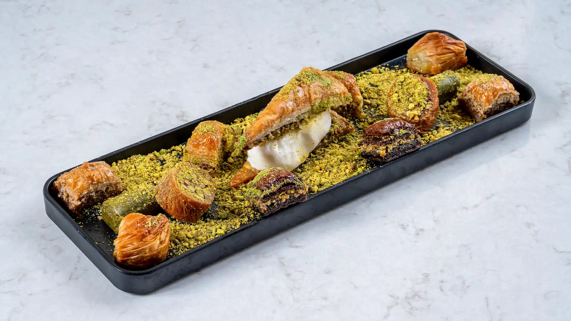 Assorted selection of freshly baked sweets and pastries served on a tray in a modern café environment at Moda Cafe & Bakery