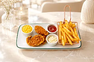 Kids chicken tenders 3 pcs with french fries served as a tasty children’s meal.