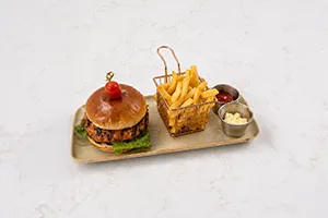 Juicy grilled burger new at Moda Cafe featuring fresh ingredients and flavorful sides.